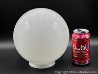 White opaque glass globe 8 inches diameter with fitted neck for lamp mounting shown next to soda can for size reference.