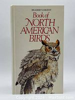 Front cover of 'Book of North American Birds' featuring an illustrated owl on white background.
