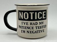 Front view of cream and black ceramic mug with text: 'NOTICE I'VE HAD MY PATIENCE TESTED I'M NEGATIVE.'