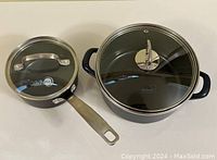 GreenPan and Kochstar cooking pots shown from above with lids on, highlighting handles and lids.