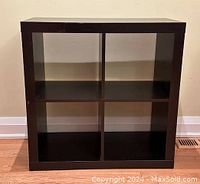 Front view of IKEA Kallax shelving unit showing four square compartments.