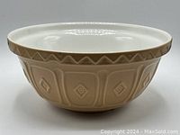 Side profile of large beige Mason Cash Cane mixing bowl showing the embossed diamond pattern and cane decorative rim detail.