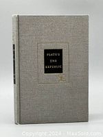 Front cover view of hardcover book titled 'PLATO'S THE REPUBLIC' in black and gold on light gray cloth.