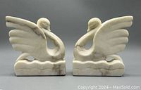 Front view of both swans side by side on neutral background