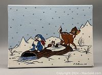 Front view of oil painting depicting Bambi, a blue rabbit, and a chipmunk near a snow-covered log and snowy mountains in background. Signed lower right 'L.D. Balestra 98'.
