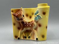 Front view showing yellow ceramic vase with 3D deer and butterfly motif.