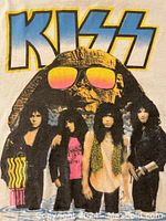 Front view of white KISS t-shirt featuring band members and large KISS logo with 'Hot in the Shade' text.
