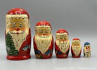 Set of five vintage Santa Claus nesting dolls arranged by size from tallest to smallest with clear frontal view.