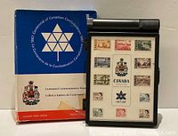 Box with original packaging and visible logo of 1967 Centennial on lid with 12 stamps displayed.
