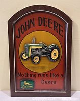 Front view of John Deere wood wall art with 3D tractor and logo, showing text 'Nothing runs like a Deere'.