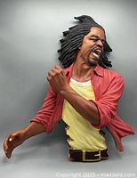 Front view of the large resin 3D wall sculpture showing the musician mid-performance with detailed hair, facial expression, and clothing.