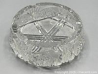 Top and side view showing intricate cut crystal patterns, thickness and ornate designs of the ashtray.