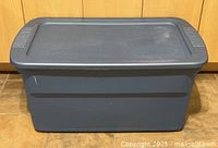 Front view of the large blue Sterilite storage bin with lid on.