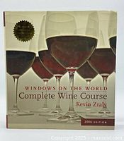 Front cover showing title, author, and wine glasses graphic with 20th Anniversary Edition seal.