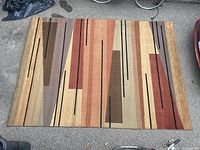 Top-down view of rectangular area rug showing full geometric pattern and color scheme