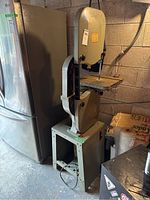 Full front view of bandsaw on stand showing frame, work table and motor base