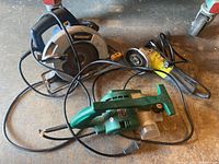 Overview photo showing all three power tools: Mastercraft circular saw, angle grinder, and planer with cables.