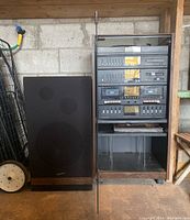 Full view of Scott stereo tower unit and one speaker showing size and condition in garage setting