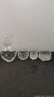 Full set showing small glass carafe and three small textured glass dishes