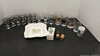 Photo of entire lot with various shot glasses and related items