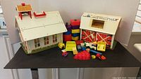 Front view of Fisher Price Family School and Farm playsets with assorted toy pieces and colorful Creative Blocks.