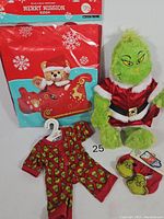 Full lot view showing Grinch plush in Santa suit, pajamas, slippers, and the boxed Merry Mission sleigh kit.