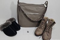 Michael Kors taupe leather purse, White Mountain beige boots, and black Ugg slippers displayed together