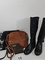Full lot showing boots, two purses, and two wallets together.
