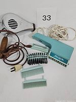 Complete set showing all items including Lady Schick Freestyle dryer, blow-n-brush attachments, combs, and vintage metallic dryer with handle.