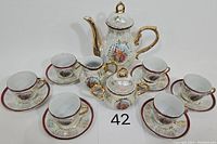 Photo of full 17 piece vintage lusterware tea set including teapot, cups, saucers, cream pitcher, and sugar bowl with lids and gold trim