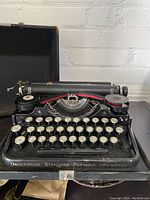 Front view of the Underwood Standard Portable typewriter with all keys visible and part of the case interior.