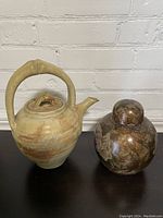 Photo showing both the tea pot and Victorian rose patterned lidded vase side by side.