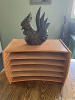 Wooden file rack with multiple paper slots, showing curved design and natural wood finish