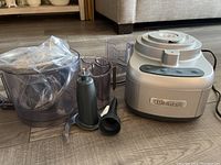 Cuisinart food processor internal parts and base on floor showing components