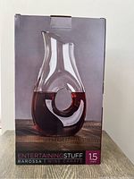 Photo of the front of the boxed wine carafe showing product image, brand, model, and volume capacity of 1.5 liters.