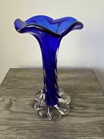 Front view of cobalt blue Murano trumpet vase showing flared wavy rim and clear glass rounded base details.