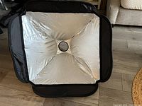 Silver interior of the photography umbrella showing the reflective fabric and central opening for camera flash or light