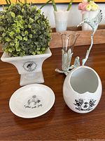 Photo showing all four items including square planter with faux greenery, ring dish, egg-shaped vase, and metal hummingbird vase holder