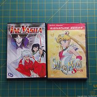 Front covers of InuYasha Seventh Season DVD set and Sailor Moon Super S The Movie DVD.