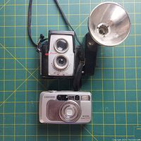 Front view of Eron twin-lens Reflex camera with external flash and Samsung compact camera