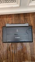 Closed view of Canon portable inkjet printer showing logo and compact body