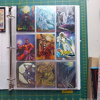 Page of Marvel collectible cards featuring Magneto, Silver Surfer, Venom, and Storm among others.