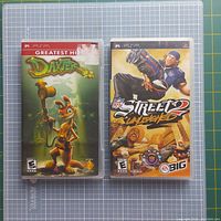 Two PSP game cases on a cutting mat: Daxter Greatest Hits and NFL Street Unleashed.