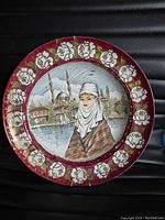 Front view of vintage 12-inch wall plate with painted scene of woman and Istanbul landmarks