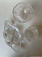Top-down view of the three crystal pieces showing their shapes and cut glass details.