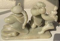 Frontal left-side view showing father kneeling, mother standing and child held aloft.