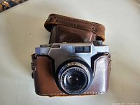 Front view of Konilette 35 camera in leather case showing lens and front body