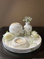 Top-down photo of the complete decorative set showing tray, vase with flowers, incense burner, and candle holder.