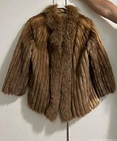 Full front view of vintage fur jacket showing vertical mink fur pattern and fox fur collar.