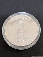 Obverse side of the coin showing Queen Elizabeth II profile with inscriptions marking the Silver Jubilee years 1952-1977 and designer name Dargent.